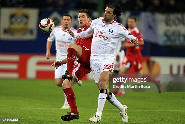 Ruud van Nistelrooy of Hamburg and Sebastien Pocognoli of Liege battle for the ball during the UEFA Europa League quarter final first leg match...