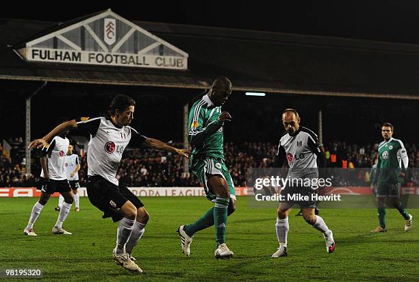 Grafite of VfL Wolfsburg is watched by Simon Davies and Danny Murphy of Fulham during the UEFA Europa League quarter final first leg match between...