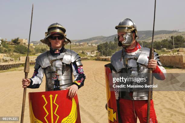 Kimi Raikkonen of Finland and Sebastien Loeb of France pose for photographs dressed as Roman gladiators before the official start of the WRC Rally...
