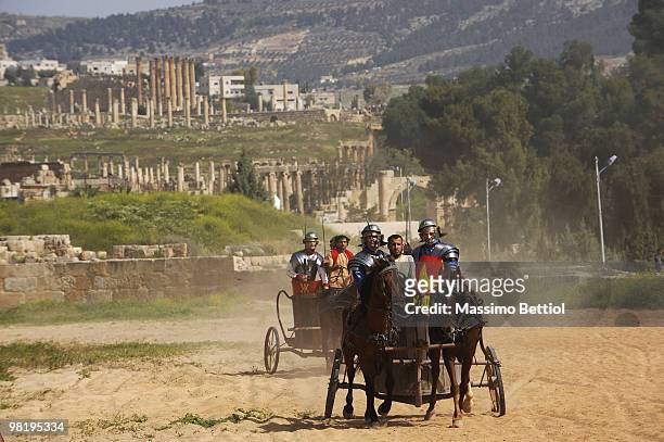 Jari Matti Latvala of Finland and Mikko Hirvonen race in chariots dressed as Roman gladiators before the official start of the WRC Rally Jordan from...