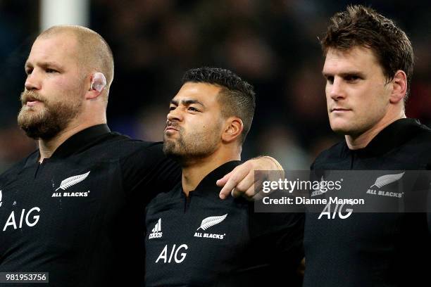 Owen Franks and Richie Mo'unga and Matt Todd of the All Blacks look on during the anthem ahead of the International Test match between the New...