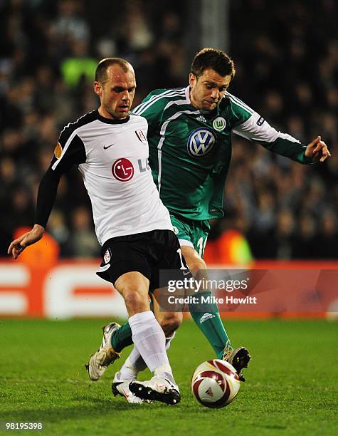 Danny Murphy of Fulham holds off Zvjezdan Misimovic of VfL Wolfsburg during the UEFA Europa League quarter final first leg match between Fulham and...