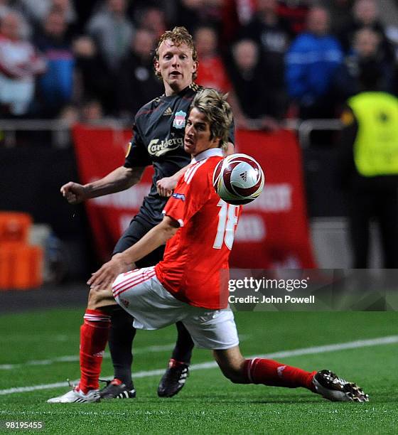 Dirk Kuyt of Liverpool kicks the ball past Fabio Coentrao of Benfica during the first leg of the UEFA Europa League quarter finals between Benfica...