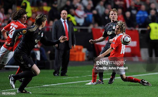 Dirk Kuyt of Liverpool kicks the ball past Fabio Coentrao of Benfica to lay Fernando Torres of Liverpool off during the first leg of the UEFA Europa...