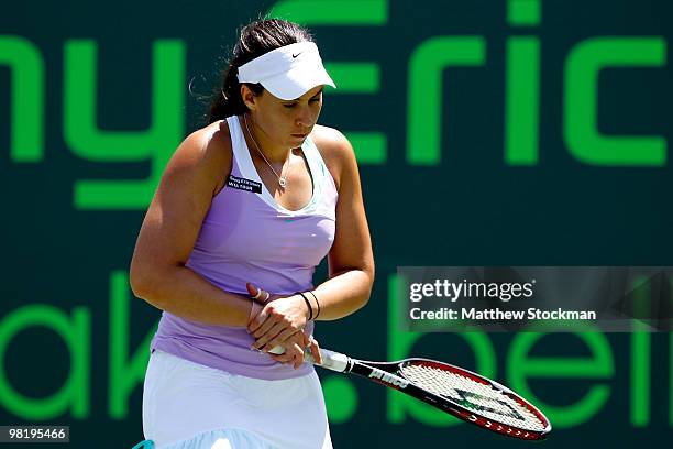 Marion Bartoli of France grabs her wrist while playing Venus Williams of the United States during day ten of the 2010 Sony Ericsson Open at Crandon...