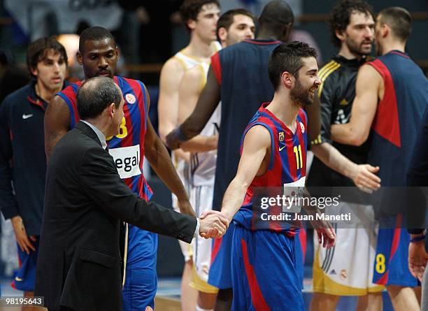 Juan Carlos Navarro, #11 of Regal FC Barcelona shakes hands with head coach Ettore Messina of Real Madrid in action during the Euroleague Basketball...