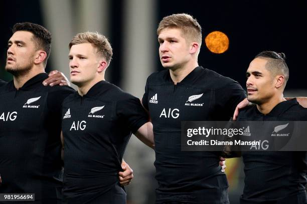 Codie Taylor, Damien McKenzie, Jack Goodhue and Aaron Smith of the All Blacks look on during the anthem ahead of the International Test match between...