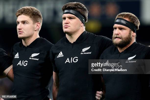 Jordie Barrett, Scott Barrett and Joe Moody of the All Blacks look on during the anthem ahead of the International Test match between the New Zealand...