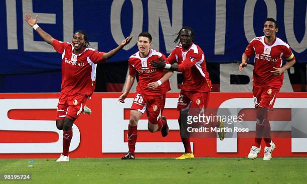 Dieudonne Mbokani of Liege celebrates with his team mates after scoring his team's opening goal during the UEFA Europa League quarter final first leg...