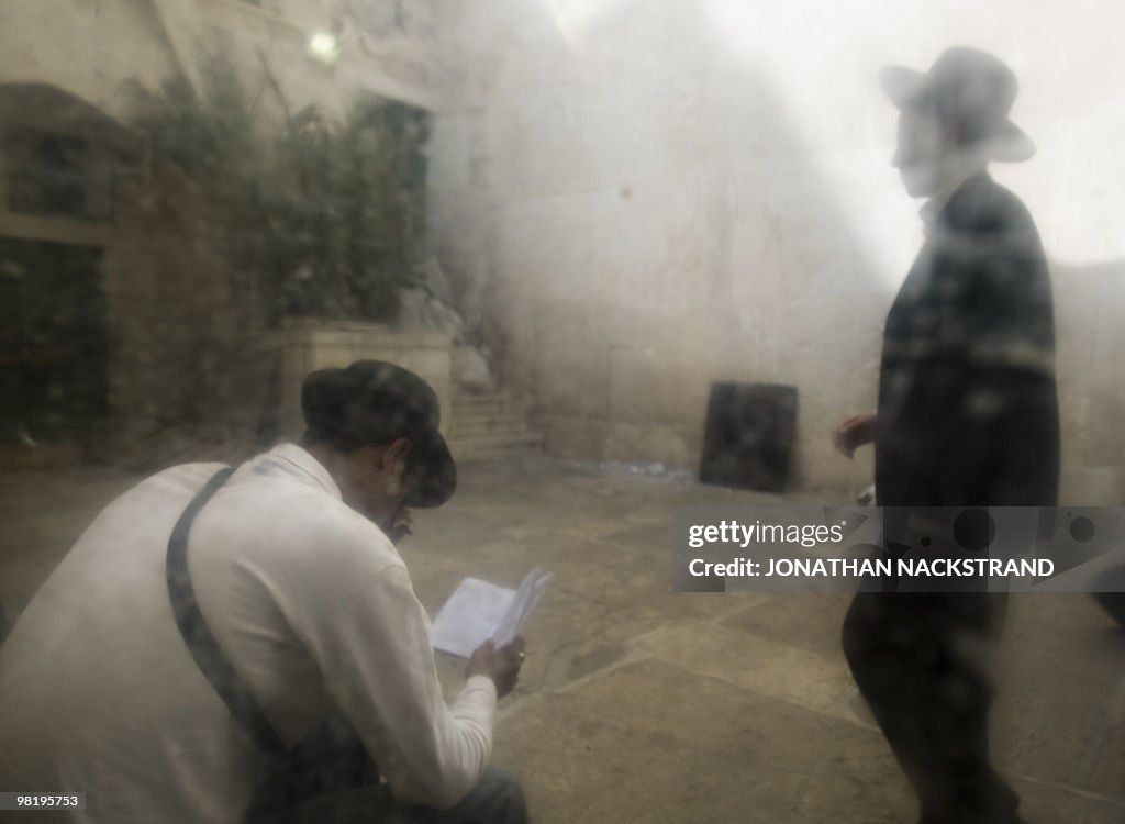 Orthodox Jewish men pray inside the Tomb