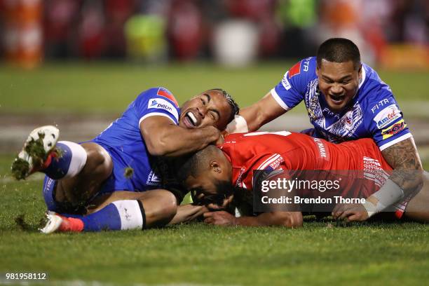 Michael Jennings of Tonga is tackled by the Samoan defence during the 2018 Pacific Test Invitational match between Tonga and Samoa at Campbelltown...