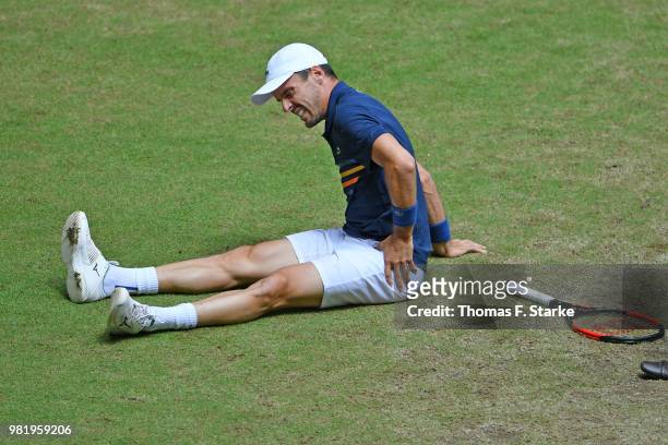 Roberto Bautista Agut of Spain reacts after picking up an injury in his half final match against Borna Coric of Croatia during day six of the Gerry...