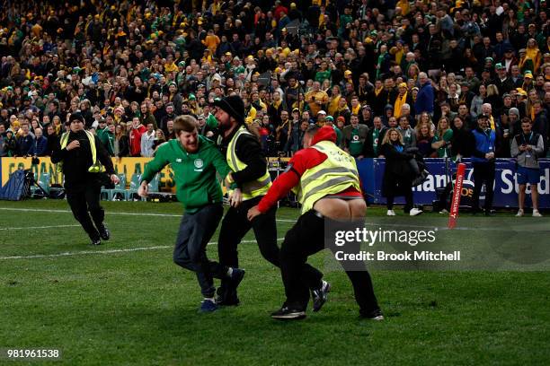 Security guard loses his pants as he chases down a pitch invader after the Third International Test match between the Australian Wallabies and...