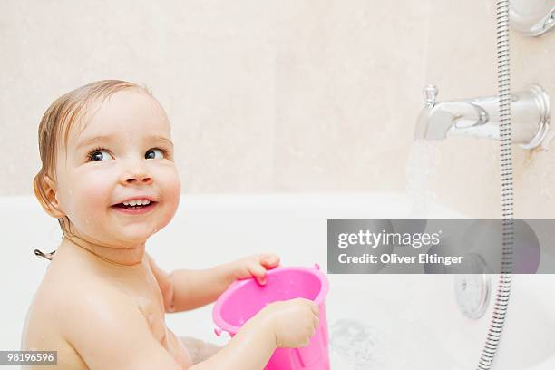 baby girl in bath - oliver eltinger stock pictures, royalty-free photos & images