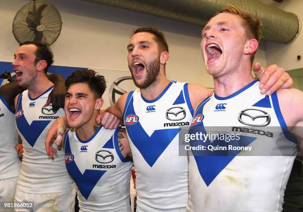 Todd Goldstein, Marley Williams, Jamie Macmillan and Jack Ziebell of the Kangaroos sing the song in the rooms after winning the round 14 AFL match...