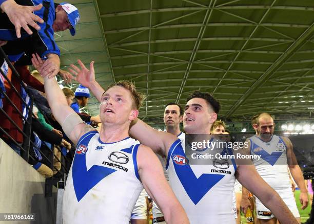 Jack Ziebell and Paul Ahern of the Kangaroos high five fans after winning the round 14 AFL match between the Western Bulldogs and the North Melbourne...