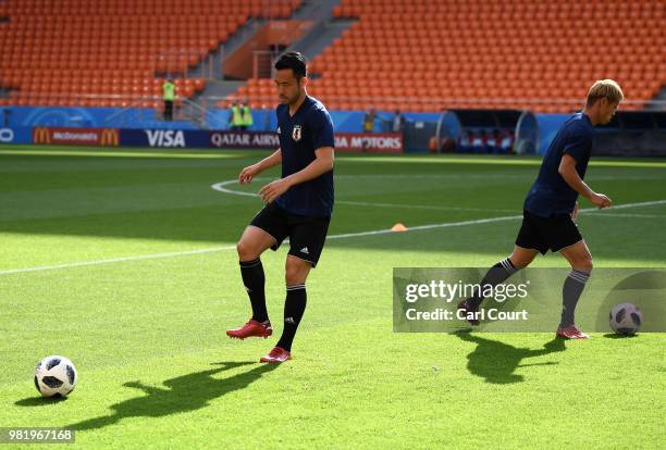 Maya Yoshida of Japan passes the ball during a Japan training session ahead of the FIFA World Cup Group H match between Japan and Senegal at...