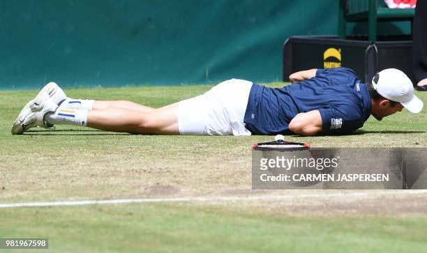 Roberto Bautista Agut from Spain lays on the court after falling and before retiring injured during his match against Borna Coric from Croatia at the...