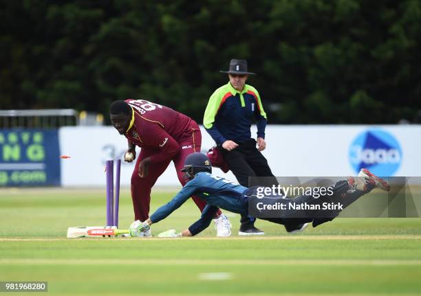 Rahkeem Cornwall of West Indies runs out Ben Foakes of England during the Tri-Series International match between England Lions and West Indies A at...