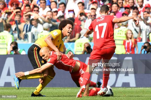 Belgium's midfielder Axel Witsel is challenged by Tunisia's defender Yohan Benalouane during the Russia 2018 World Cup Group G football match between...