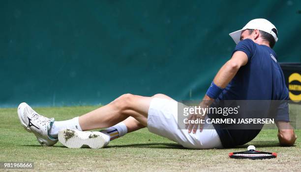 Roberto Bautista Agut from Spain sits on the court after falling and before retiring injured during his match against Borna Coric from Croatia at the...