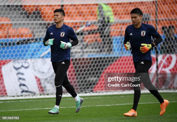 Eiji Kawashima of Japan and Kosuke Nakamura of Japan warm up during a Japan training session ahead of the FIFA World Cup Group H match between Japan...