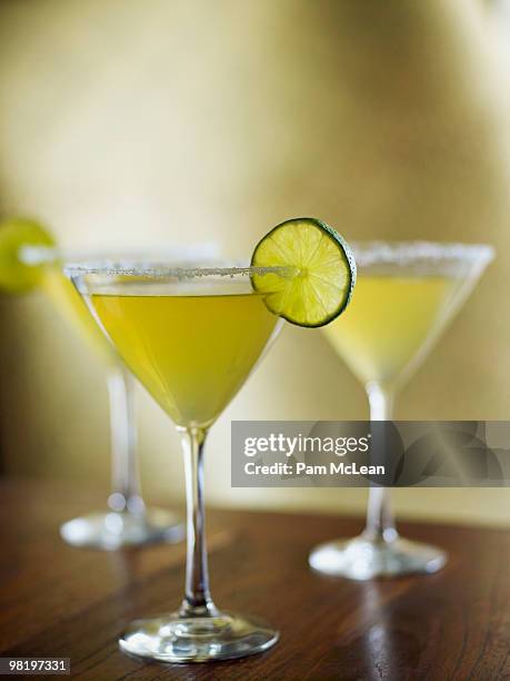 margaritas with limes - cocktail glass salt stock pictures, royalty-free photos & images