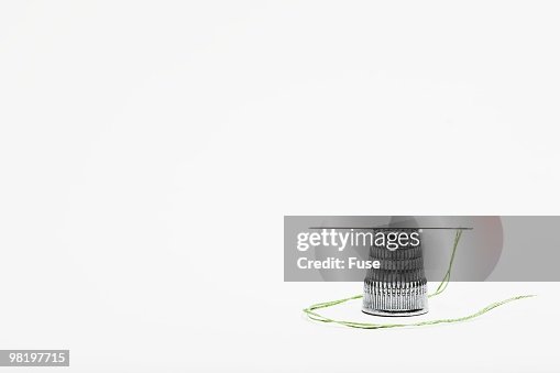 Thimble and threaded needle Thimble and threaded needle