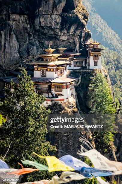 a cliffside monastery in paro, bhutan. - bhutan stock pictures, royalty-free photos & images