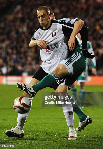 Bobby Zamora of Fulham tangles with Andrea Barzagli of VfL Wolfsburg during the UEFA Europa League quarter final first leg match between Fulham and...