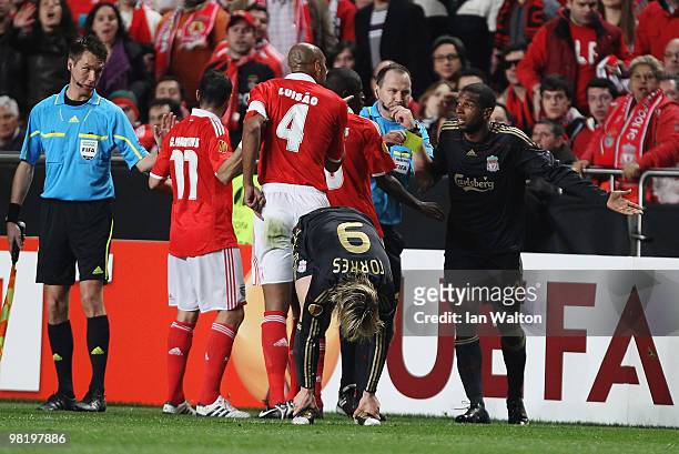 Referee Jonas Eriksson intervenes following a Luisao challenge on Fernando Torres, showing Ryan Babel of Liverpool a red card and Luisao a yellow...