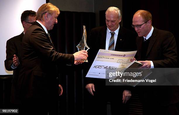 Former football player and youth trainer at the DFB Horst Hrubesch receives the Football Trainer of the year 2009 award from Matthias Sammer at the...