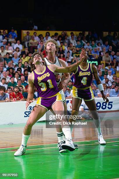 Kurt Rambis of the Los Angeles Lakers boxes out against Larry Bird of the Boston Celtics during the 1985 NBA Finals at the Boston Garden in Boston,...