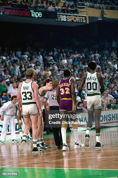 Larry Bird and Robert Parish of the Boston Celtics walk with Magic Johnson of the Los Angeles Lakers during the 1985 NBA Finals at the Boston Garden...