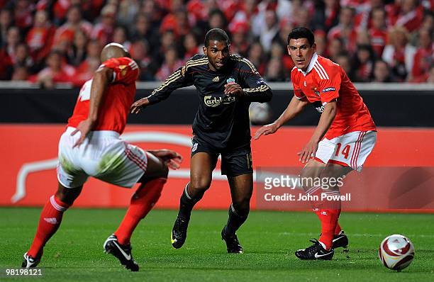 Ryan Babel of Liverpool competes with Luisao and Maxi Pereira of Benfica during the UEFA Europa League quarter final first leg match between Benfica...