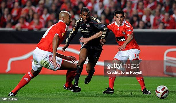 Ryan Babel of Liverpool competes with Luisao and Maxi Pereira of Benfica during the UEFA Europa League quarter final first leg match between Benfica...