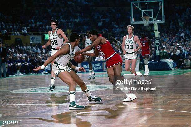 Julius Erving of the Philadelphia 76ers drives against Dennis Johnson of the Boston Celtics during a game played in 1985 at the Boston Garden in...