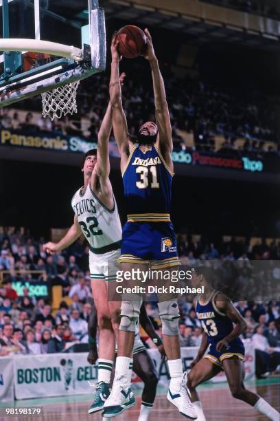 Granville Waiters of the Indiana Pacers rebounds against Kevin McHale of the Boston Celtics during a game played in 1985 at the Boston Garden in...