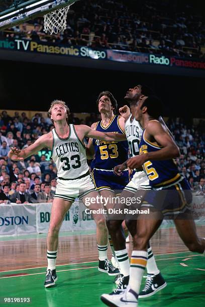 Larry BIrd of the Boston Celtics boxes out against Mark Eaton of the Utah Jazz during a game played in 1985 at the Boston Garden in Boston,...