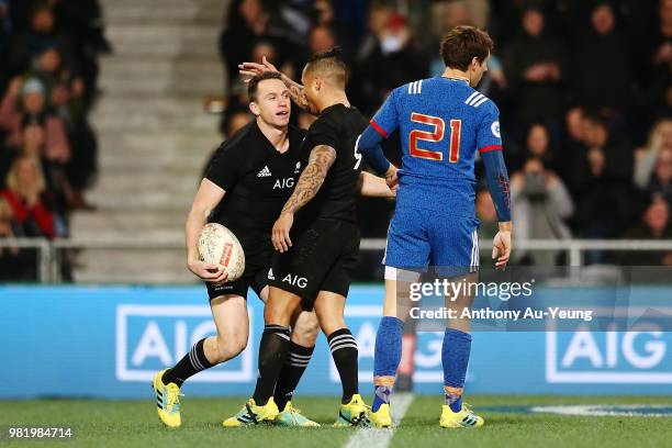 Ben Smith of the All Blacks celebrates with teammate Aaron Smith after scoring a try during the International Test match between the New Zealand All...