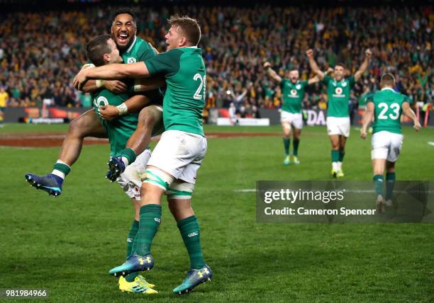 Bundee Aki of Ireland celebrates winning with team mates Johnny Sexton and Jordi Murphy of Ireland during the Third International Test match between...