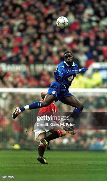 Ade Akinbiyi of Leicester Citywins an aerial duel during the FA Carling Premiership match between Manchester United v Leicester City at Old Trafford,...