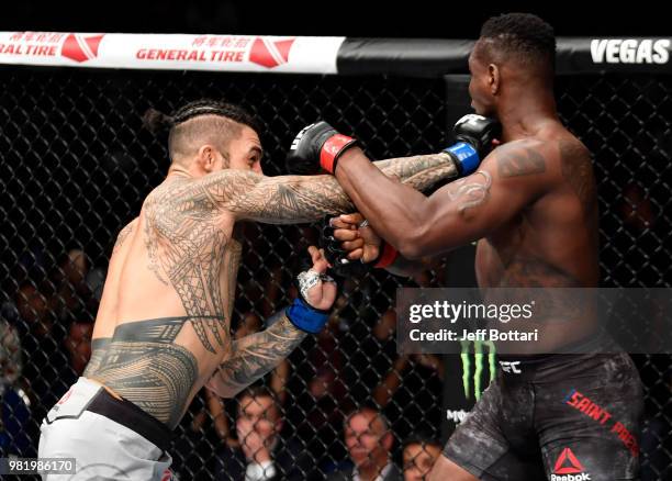 Tyson Pedro of Australia punches Ovince Saint Preux in their light heavyweight bout during the UFC Fight Night event at the Singapore Indoor Stadium...