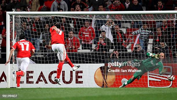 Oscar Cardozo of Benfica scores from the penalty spot past Pepe Reina of Liverpool during the UEFA Europa League quarter final first leg match...