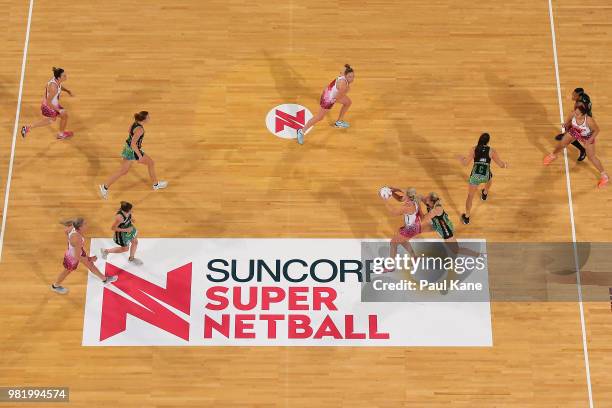 Chelsea Pitman of the Thunderbirds passes the ball against Jessica Anstiss of the Fever during the round eight Super Netball match between the Fever...