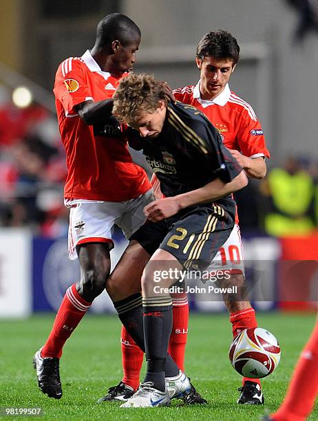 Lucas Leiva of Liverpool competes with Pablo Aimar of Benfica during the UEFA Europa League quarter final first leg match between Benfica and...