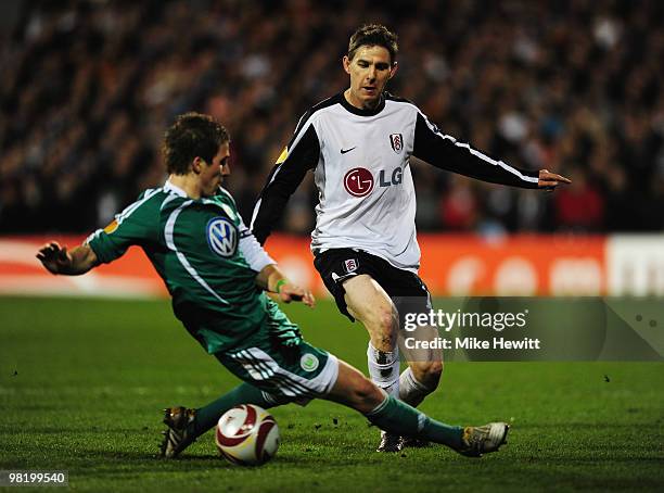 Zoltan Gera of Fulham is tackled by Peter Pekarik of VfL Wolfsburg during the UEFA Europa League quarter final first leg match between Fulham and Vfl...