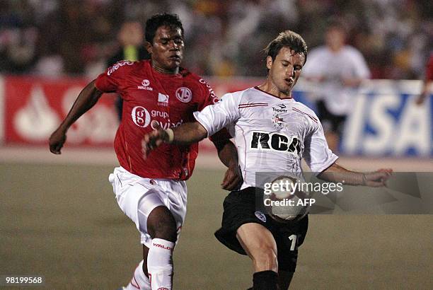 Peru´s Jersson Vasquez from Juan Aurich fights for the ball against Gaston Fernandez from of Argentina's Libertad, during their Copa Libertadores...