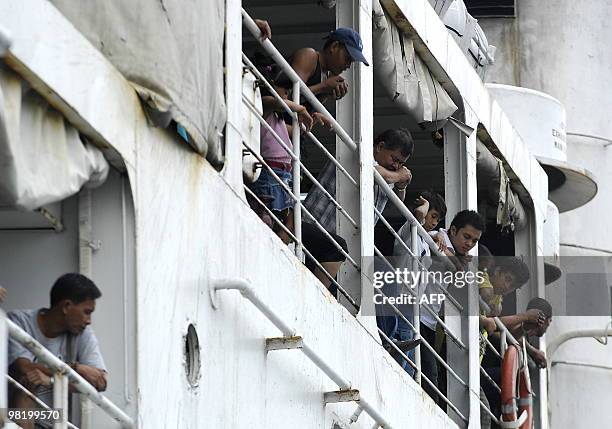 Passengers look out from a shipping vessel at north harbour in Manila on March 30, 2010. Most of Filipinos spend the Holy Week running up to Easter...