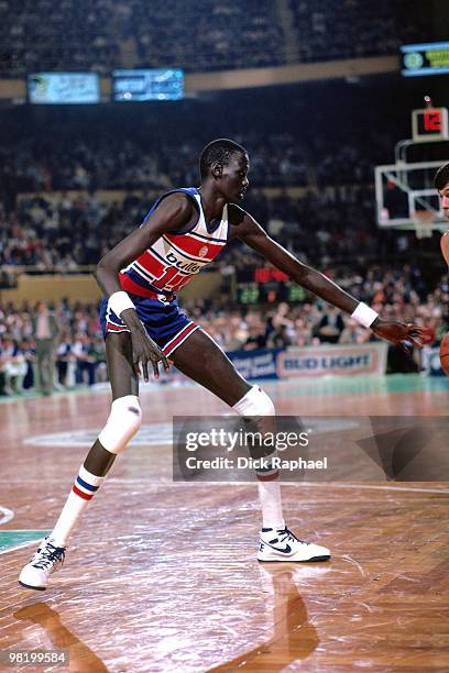 Manute Bol of the Washington Bullets defends against the Boston Celtics during a game played in 1985 at the Boston Garden in Boston, Massachusetts....